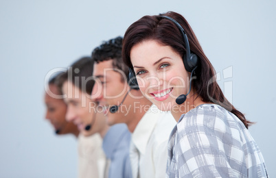 Attractive business woman and her team working in a call center