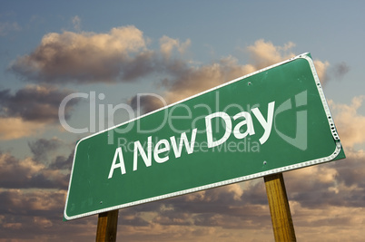 A New Day Green Road Sign with dramatic clouds and sky..