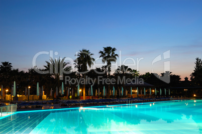 Swimming pool and sunset at popular hotel, Antalya, Turkey
