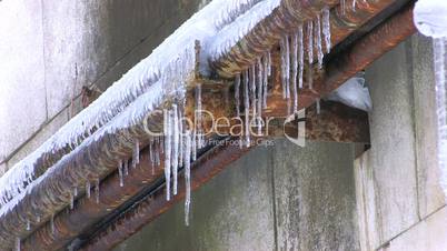 HD Icicles hanging from rusty pipe