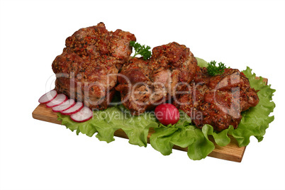 Smoked chicken kebab on wooden board.