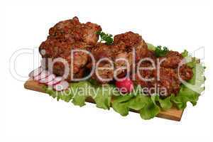 Smoked chicken kebab on wooden board.