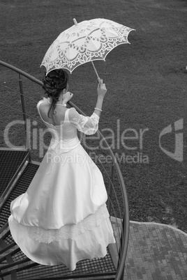 Bride with umbrella. BW.