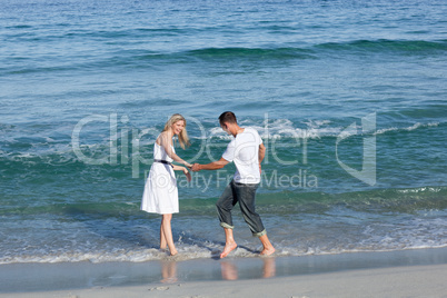 Loving couple having fun at the shore line