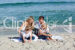 Happy family playing on the sand