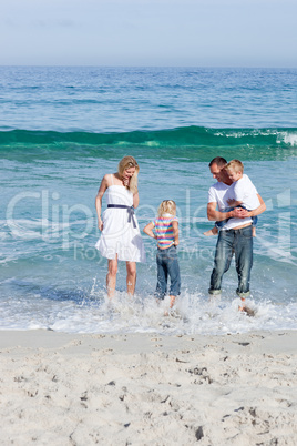 Cheerful family having fun at the beach