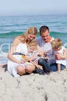 Smiling mother with her family holding sunscreen