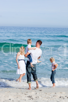 Affectionate family having fun at the beach