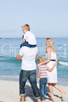 Affectionate family walking on the sand