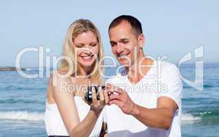 Enamored couple looking at holiday photograph