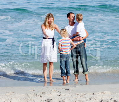 Happy family having fun on the sand