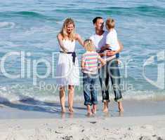 Happy family having fun on the sand