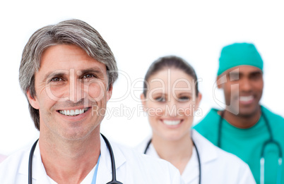 Focus on a mature doctor in front of his team