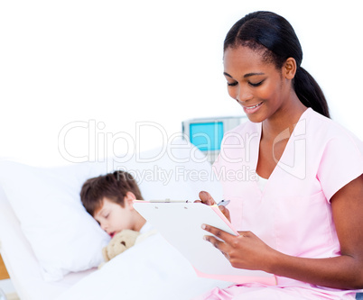Smiling doctor making notes on a patient's clipboard