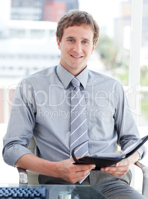 Young male executive looking at his agenda