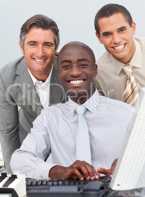 Multi-ethnic businessmen working at a computer
