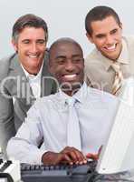 Smiling businessmen working at a computer