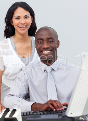 Multi-ethnic business team working at a computer