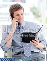 Serious businessman planning an appointment on phone