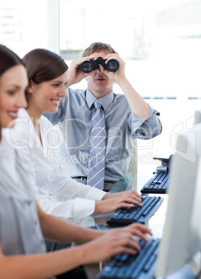 Animated businessman looking through binoculars in the office