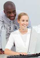 Ethnic businessman and his colleague working at a computer