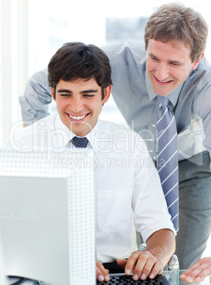 Two serious businessmen working at a computer