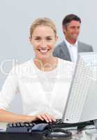 Smiling businesswoman working at her computer