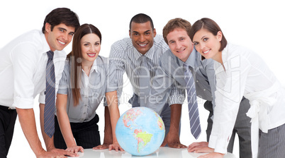 Portrait of business team around a terrestrial globe
