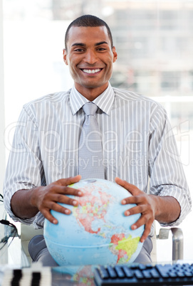 Enthusiastic businessman showing a terrestrial globe