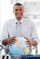 Enthusiastic businessman showing a terrestrial globe