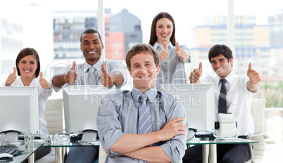Positive business people with thumbs up