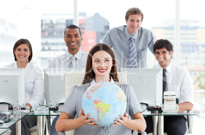 Pretty businesswoman and her team showing a terrestrial globe