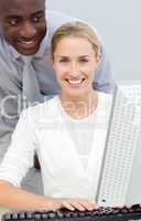 Afro-american businessman and his colleague working at a compute
