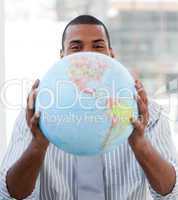Fortunate businessman holding a terrestrial globe