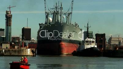 RFA Orangeleaf being towed into dock