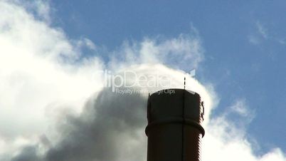 Smoke pouring out of an industrial chimney