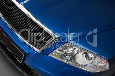 headlight and grate of radiator on a dark blue car