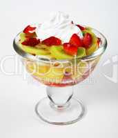 Summer fruit salad with cream on white background