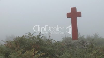 Cross in fog on mountain