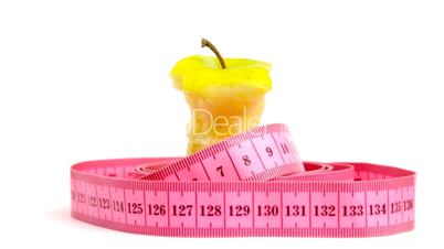 Tape measure wrapped around rotating apple core, loopable