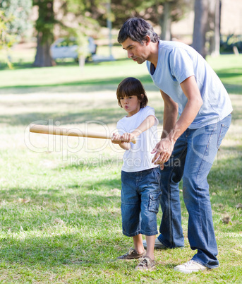 Charming father teaching baseball to his son