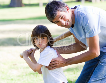 Portrait of a father teaching baseball to his son