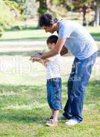 Loving little boy playing baseball with his father