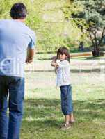 Jolly little boy playing baseball with his father