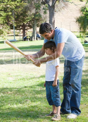 Attentive father teaching baseball to his son