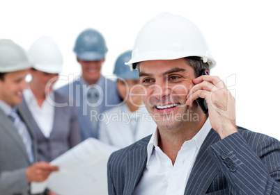 Mature male architect on phone standing