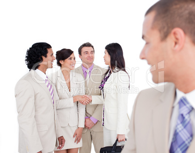 Positive business co-workers shaking hands