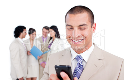 Cheerful businessman sending a text