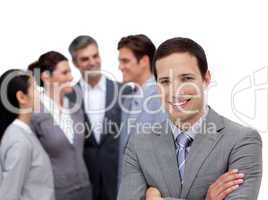 Positive businessman with folded arms standing with his team
