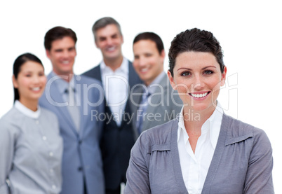 Happy businesswoman with folded arms standing with his team